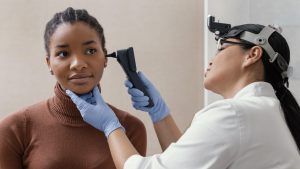 medium-shot-doctor-checking-patient-ears