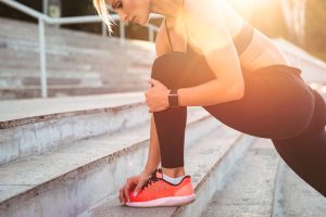 Cropped photo of strong young sports woman stretching