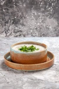 front-view-tasty-dovga-yogurt-soup-with-greens-white-table-dairy-milk-soup-dish_140725-125236