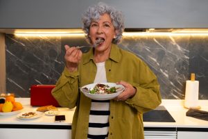 senior-woman-enjoying-homemade-figs-dish_23-2150304410