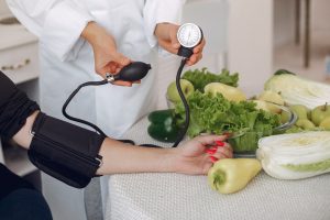 doctor-measures-pressure-patient-kitchen_1157-28047